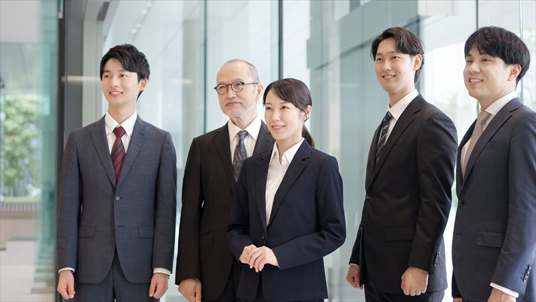 Asian business person standing with a smile